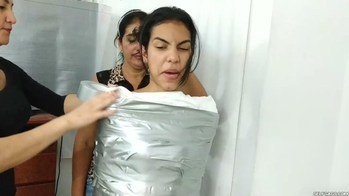 Girl-Mummified-By-Two-MILFs-9