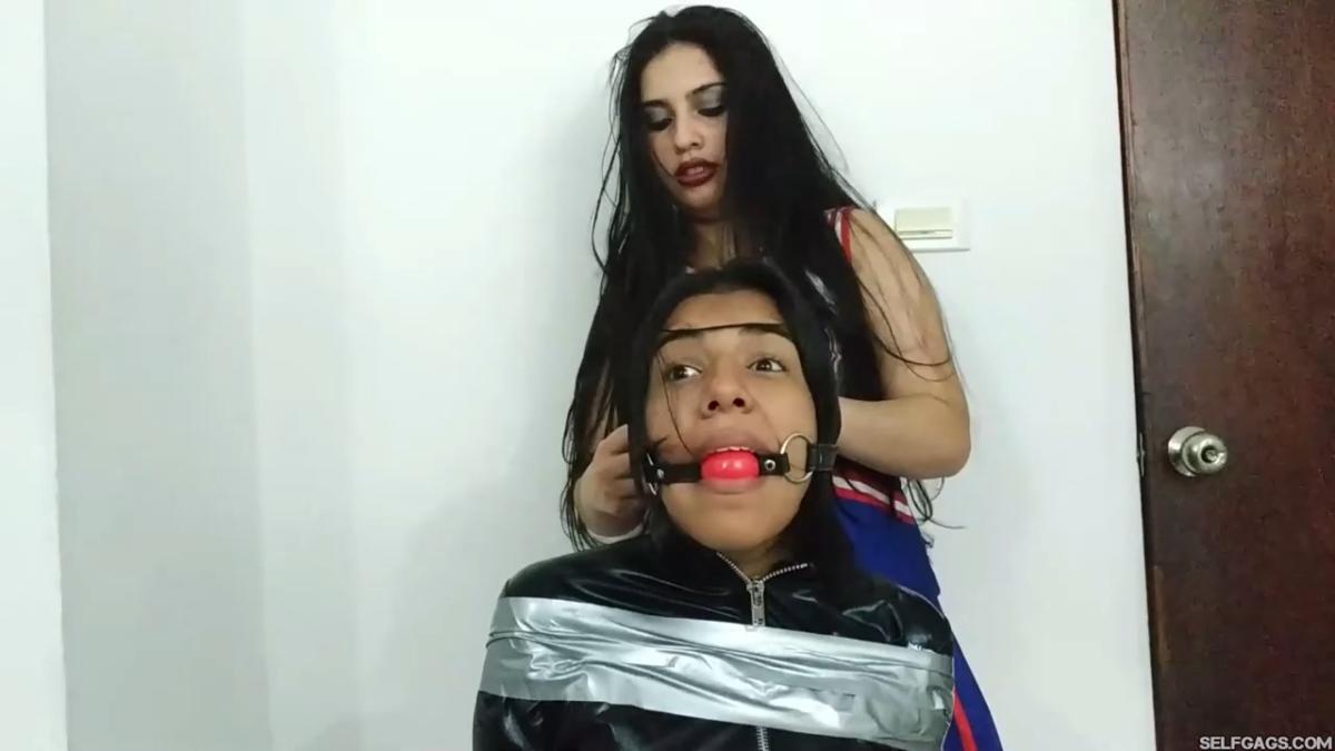 girl in catsuit bound and gagged by witch and cheerleader for halloween