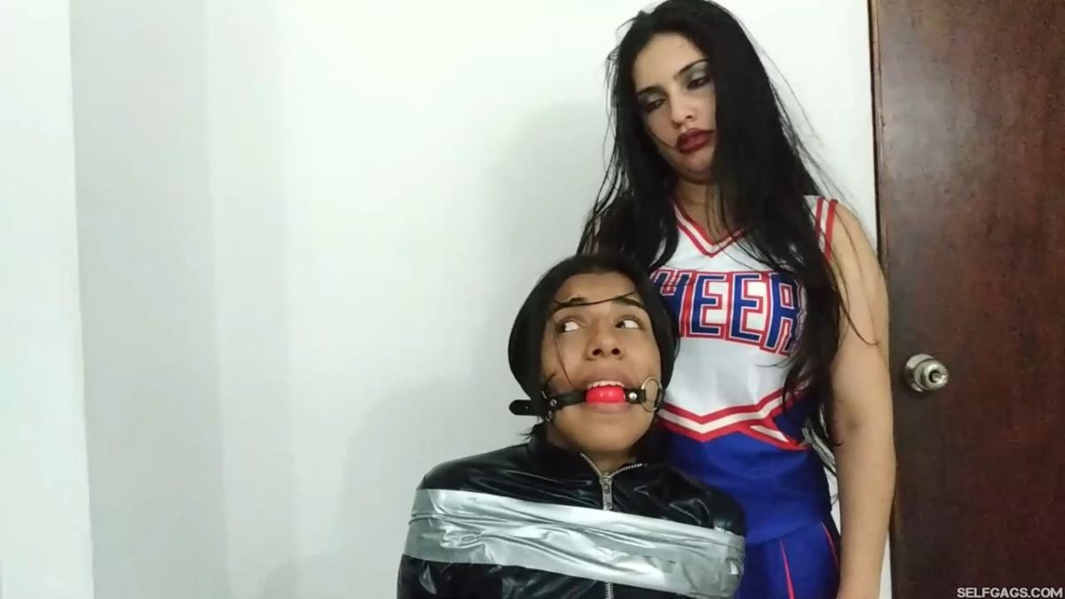 girl in catsuit bound and gagged by witch and cheerleader for halloween