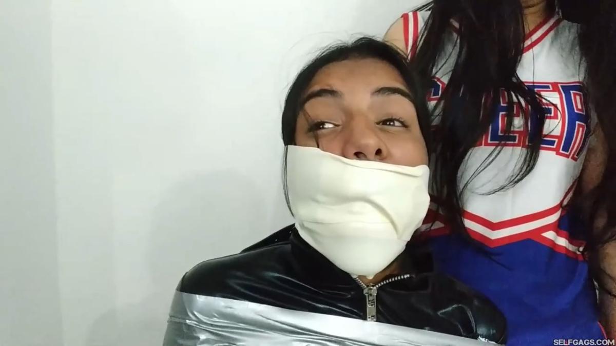 girl in catsuit bound and gagged by witch and cheerleader for halloween