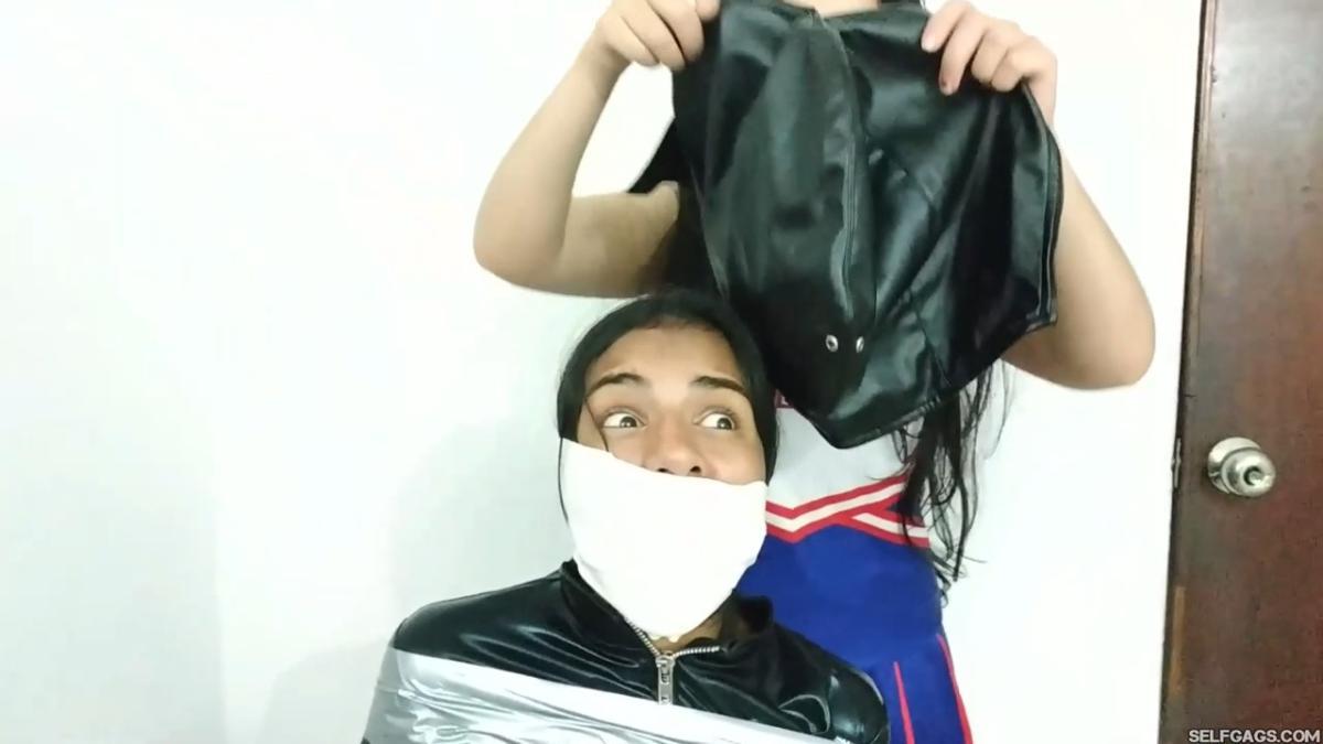 girl in catsuit bound and gagged by witch and cheerleader for halloween