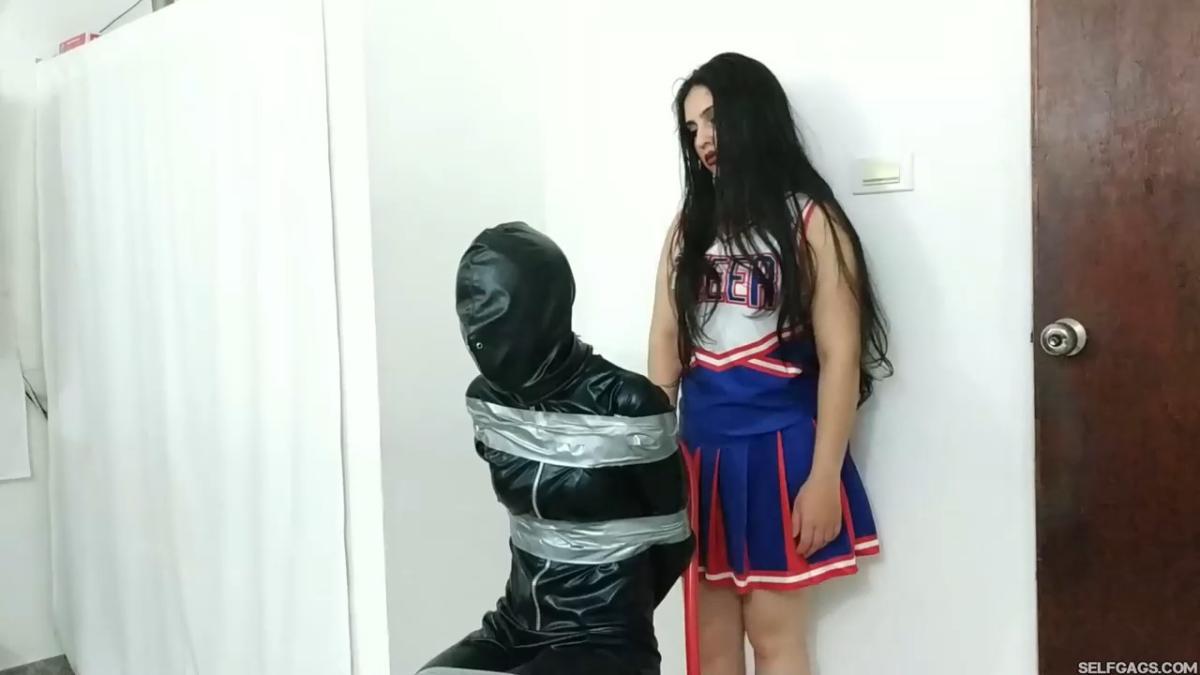 girl in catsuit bound and gagged by witch and cheerleader for halloween