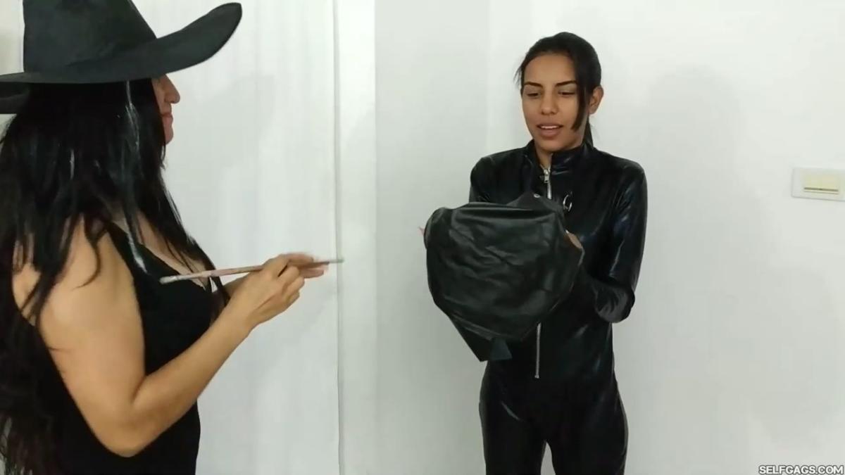 girl in catsuit bound and gagged by witch and cheerleader for halloween