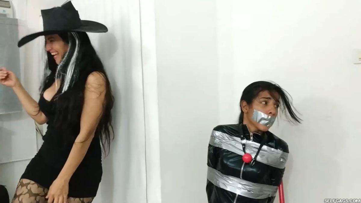 girl in catsuit bound and gagged by witch and cheerleader for halloween