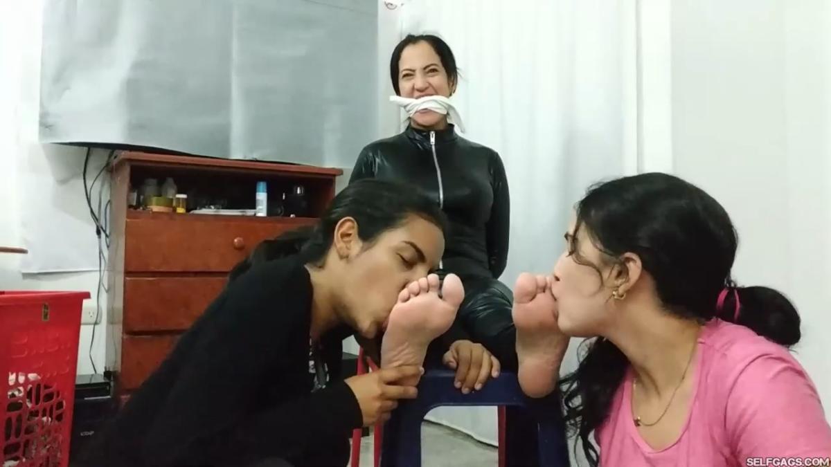 Woman in catsuit bondage gagged for foot worship