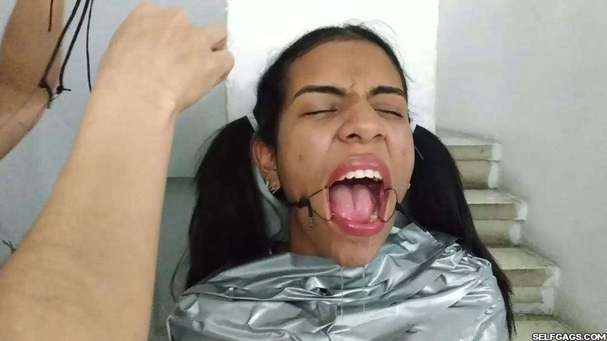 Cute girl gets duct tape mummified BDSM training by female bondage photographer