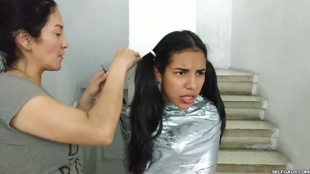 Cute girl gets duct tape mummified BDSM training by female bondage photographer