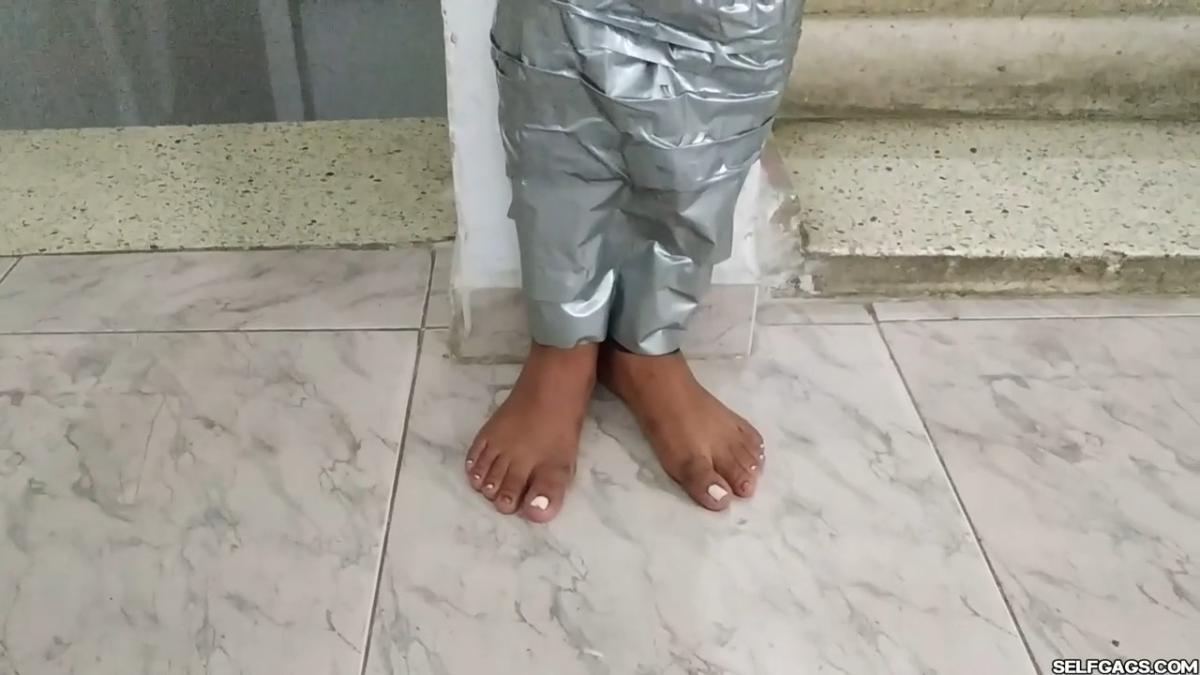Cute girl gets duct tape mummified BDSM training by female bondage photographer