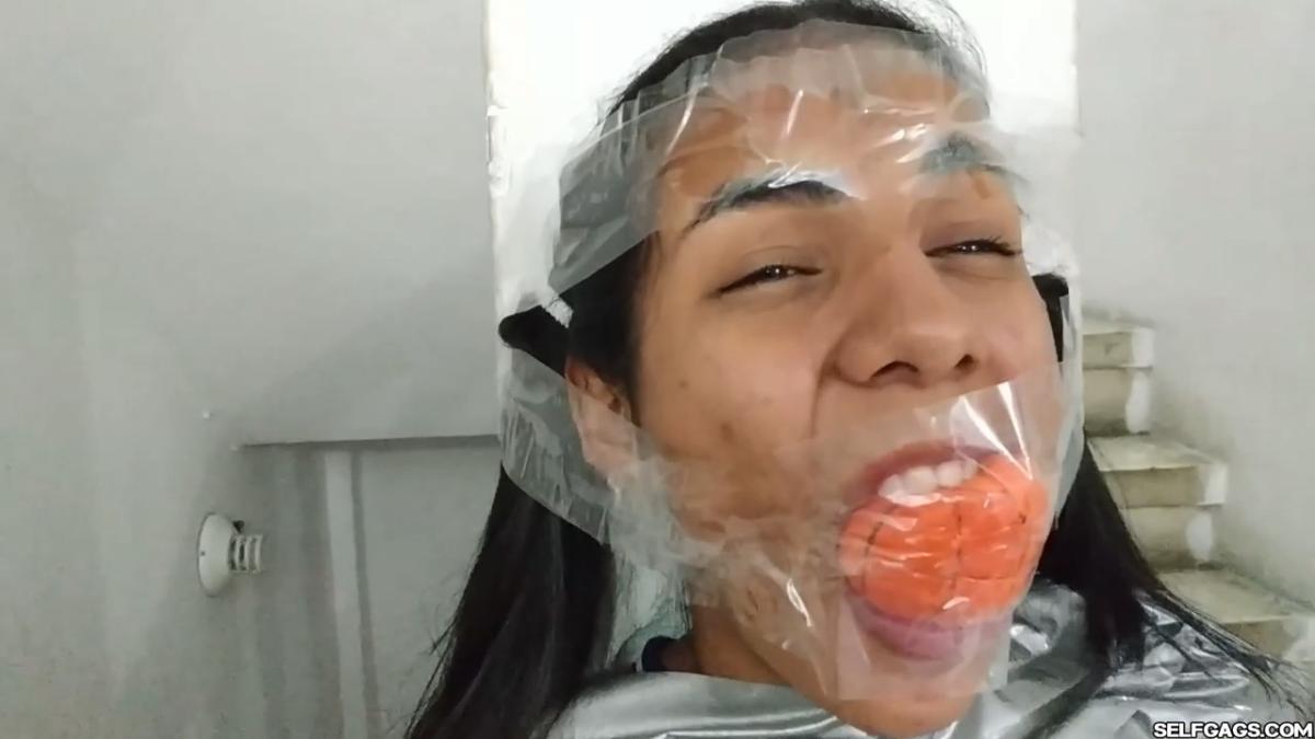 Cute girl gets duct tape mummified BDSM training by female bondage photographer