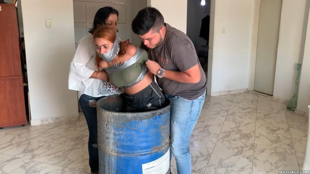 Tape-Bound-Girl-Gagged-In-Barrel-10