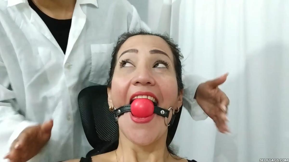 Young massage girl does foot massage on bound and gagged woman with sensual foot worship