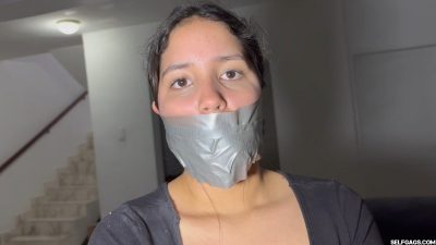 Closeup of Nana’s eyes over her thick silver duct tape gag Selfgags