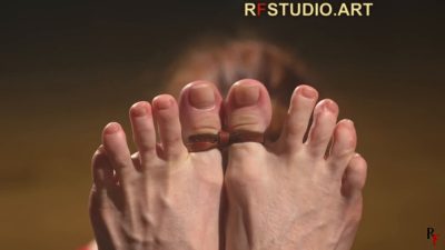 Close-up of Emily's bare big toes tied together with a thin cord
