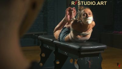 Over John's shoulder — Hayley hogtied and tape-gagged looking up