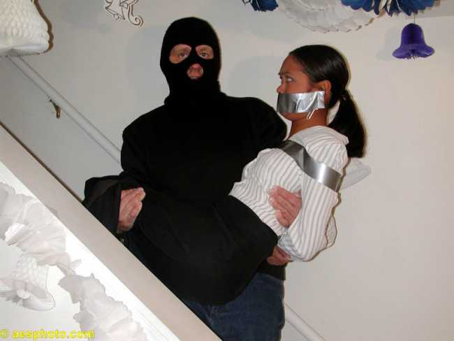 Gagged woman carried in bondage