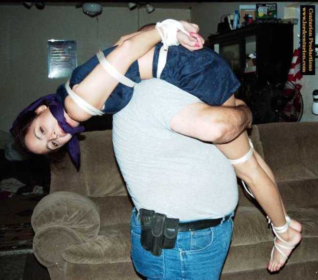 Gagged woman carried in bondage