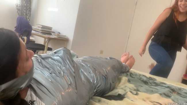 Barefoot girl gagged in tight duct tape mummification bondage