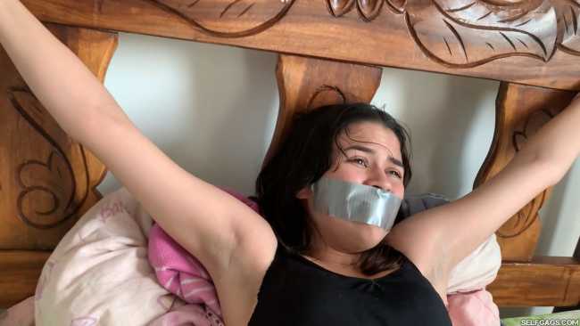 Tape gagged girl tied to bed