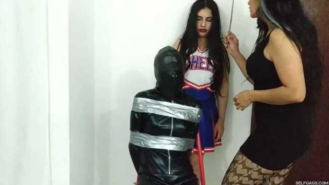girl in catsuit bound and gagged by witch and cheerleader for halloween