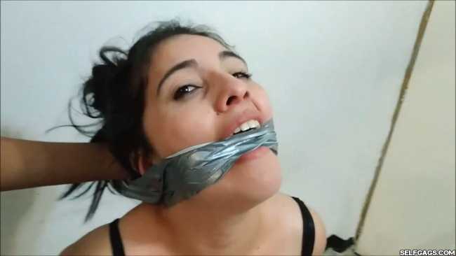 Girl wearing underwear is duct tape hogtied and gagged