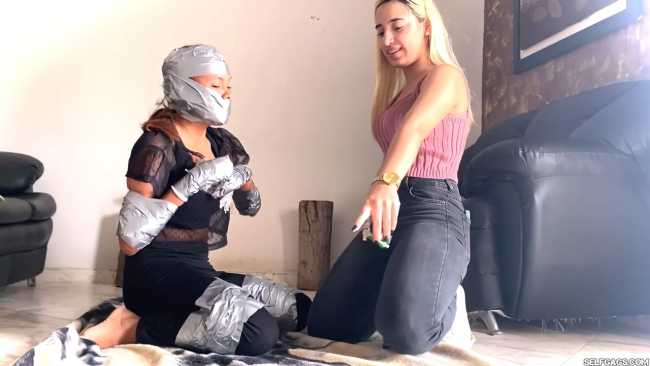 Blonde BDSM mistress wants her roommate bound and gagged in tape bondage