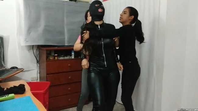 Woman in catsuit bondage gagged for foot worship