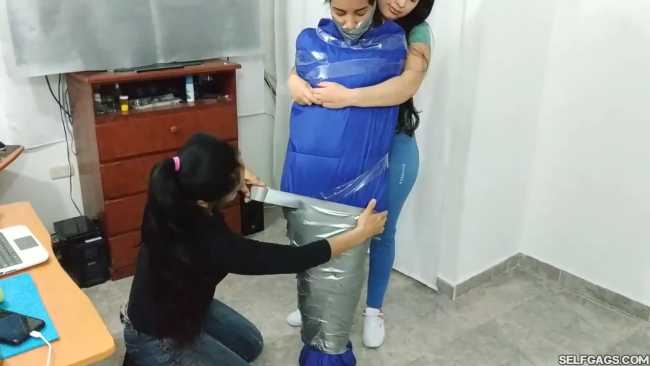 Gagged girl in duct tape mummification bondage