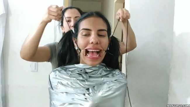 Cute girl gets duct tape mummified BDSM training by female bondage photographer