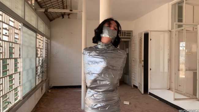 Stranded-Girl-Pole-Mummified-And-Tape-Gagged-1