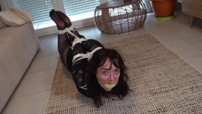 Boyfriend forcing both socks toward her mouth while she is rope-bound on the sofa