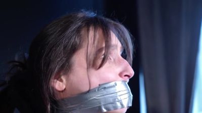 Side profile of Cloudy’s face sealed under wrinkled silver duct tape